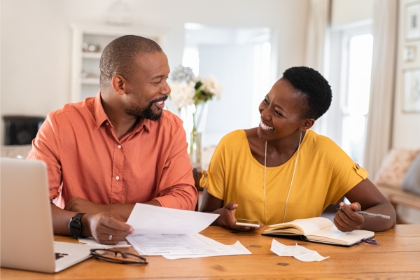 smiling couple managing home finances