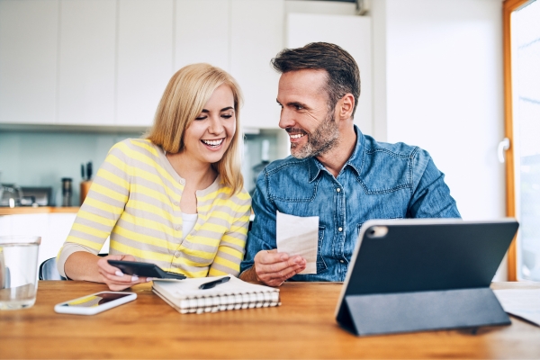 happy couple managing home finances