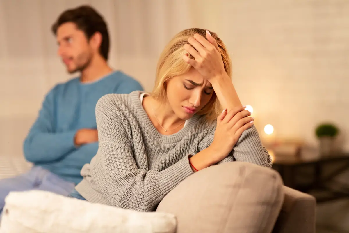 frustrated woman sitting next to woman after betrayal in marriage