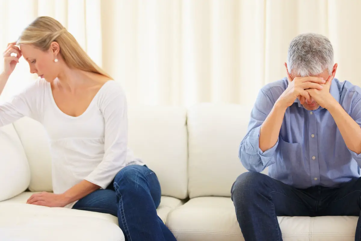 unhappy couple sitting in sofa