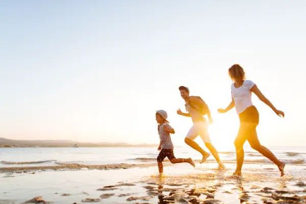 happy family running on beach