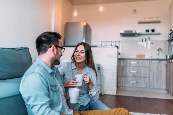 couple talking in happy mood while drinking coffee 
