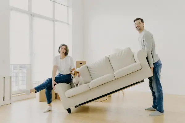 couple setting furniture as a new home
