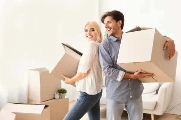 married couple setting furniture as a new home